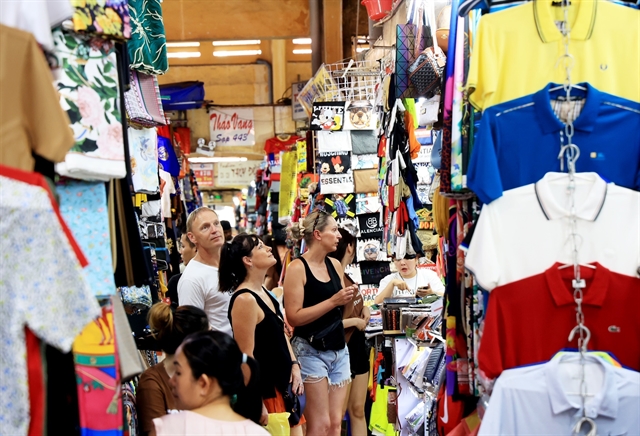 Foreign visitors walking inside Ben Thanh Market in Ho Chi Minh City