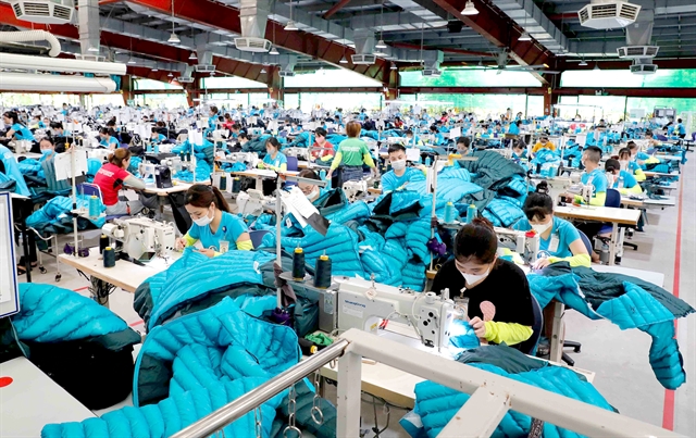 Workers sewing garments for export at Maxport Thai Binh Garment Co. in Vietnam