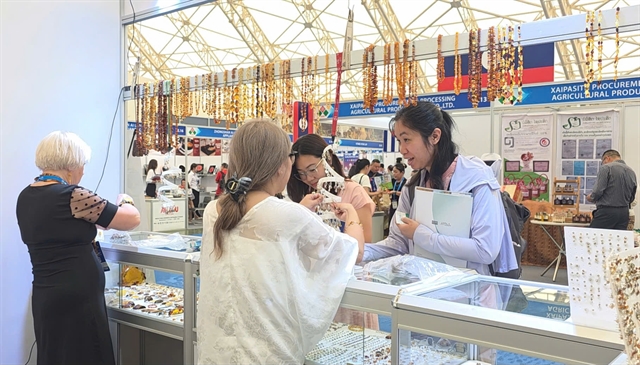 A Polish exhibitor talks to visitors at Vietnam Expo 2026 in Hanoi