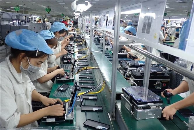 Workers assemble mobile phone components at Diem Thuy Industrial Park in Thai Nguyen province, Vietnam